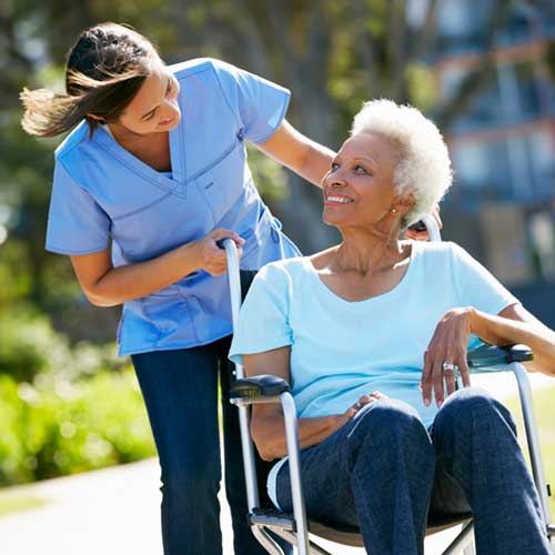 A home care caregiver helps a senior elderly woman in Irvin Texas.